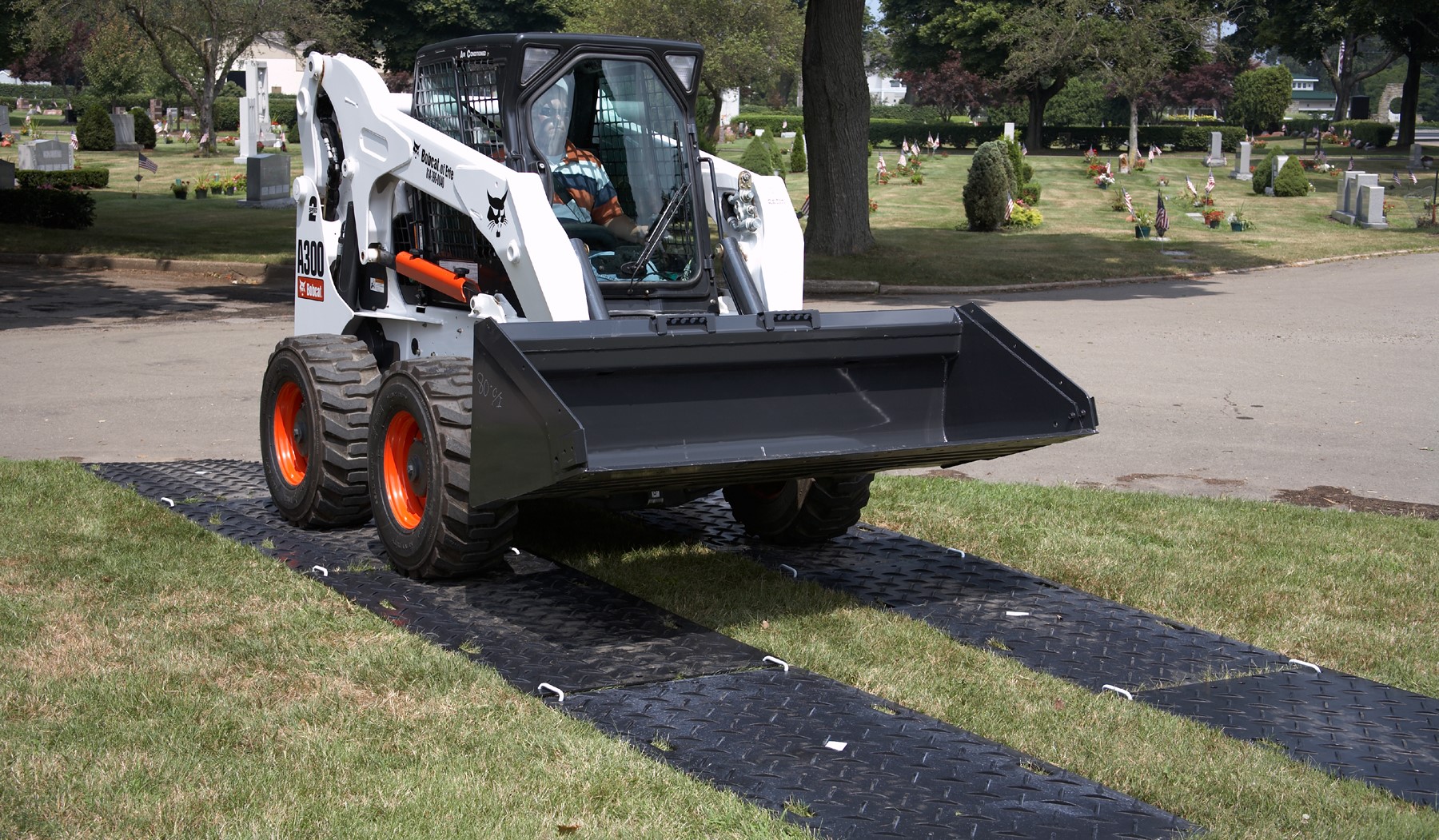 Construction mats protect lawn from damage caused by skid steer