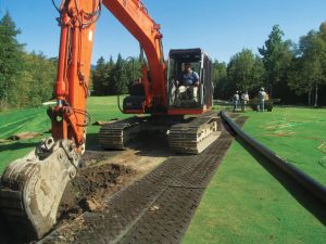 Access mats protect turf from excavator
