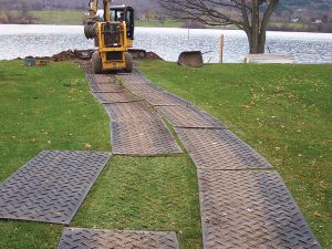Temporary roadway of mats for skid steer
